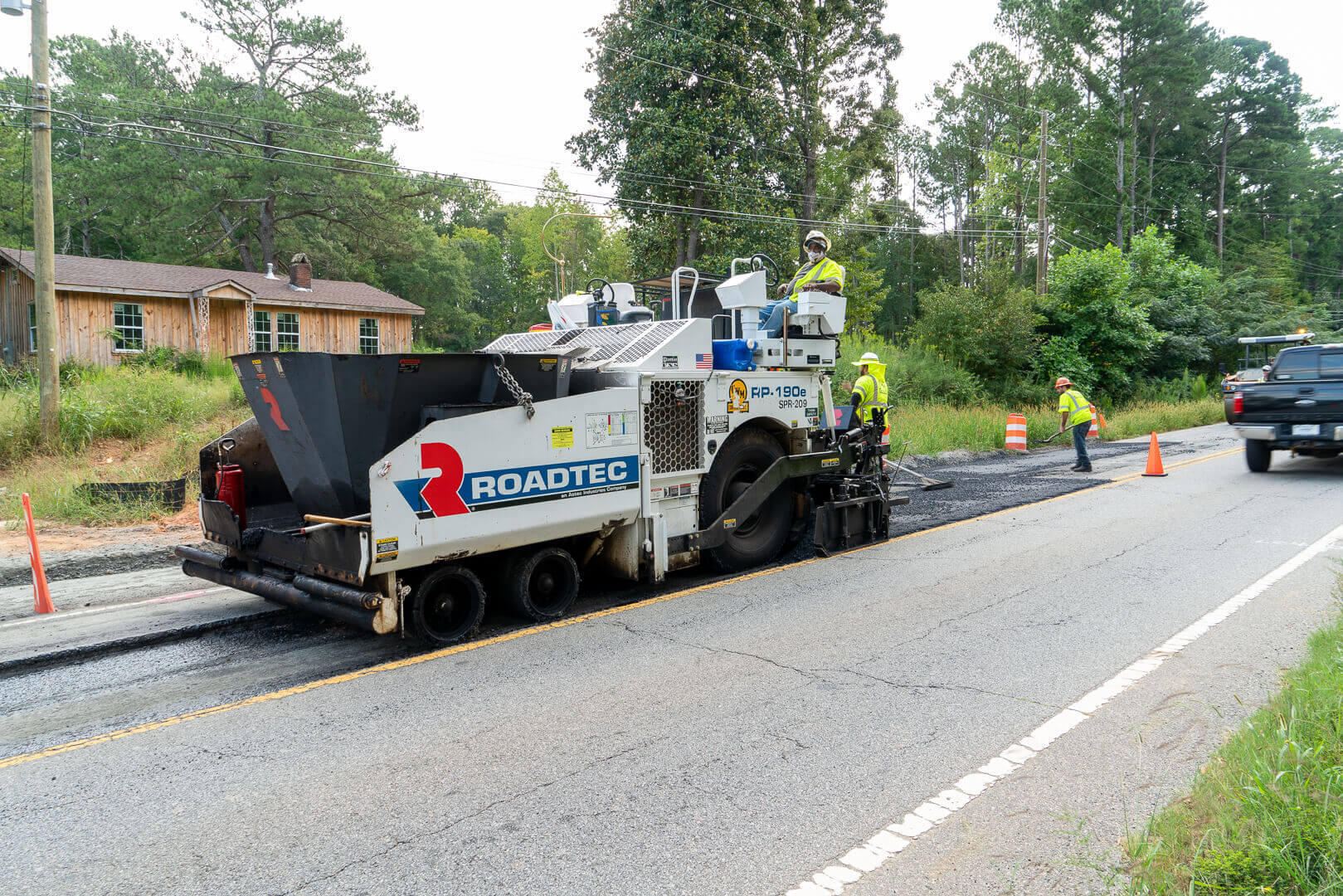 Roadtec RP-190 Highway Class Asphalt Paver paving with hopper insert