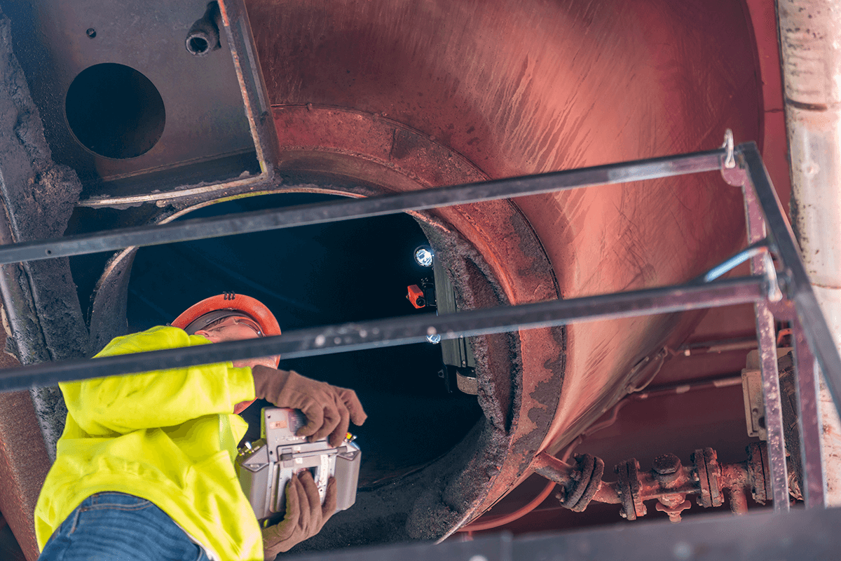 Astec Silobot inspecting the inside of a cone of an asphalt storage silo