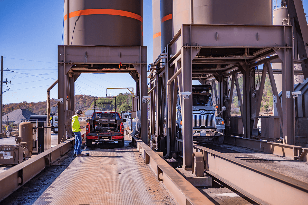 Astec Silobot inside truck inspecting a asphalt storage silo