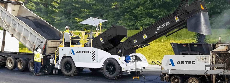 A Roadtec MTV-1100 material transfer vehicle working with a roadtec paver