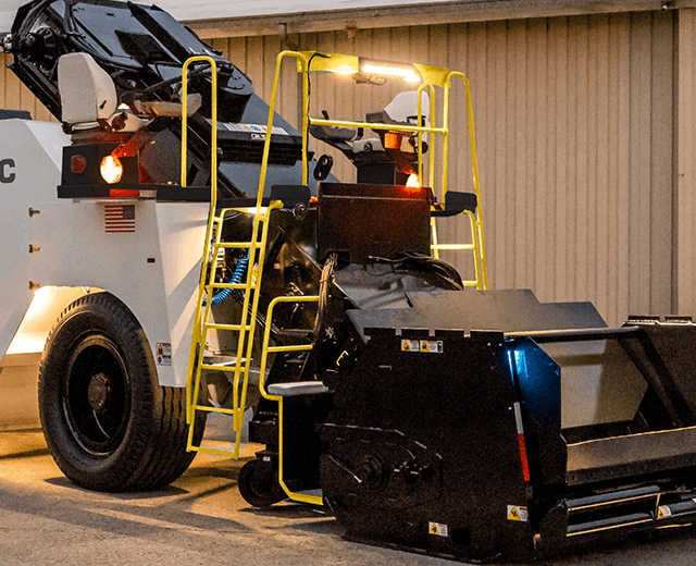 Roadtec SB-3000 Shuttle Buggy Material Transfer Vehicle showing the dual function ladder that spans the entire width of the machine