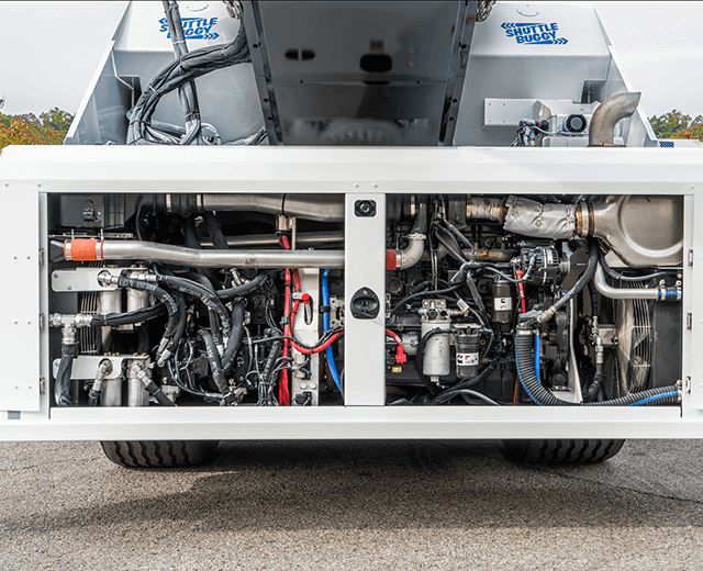 The Roadtec SB-3000 Shuttle Buggy Material Transfer Vehicle showing the engine at ground level with engine access panels open