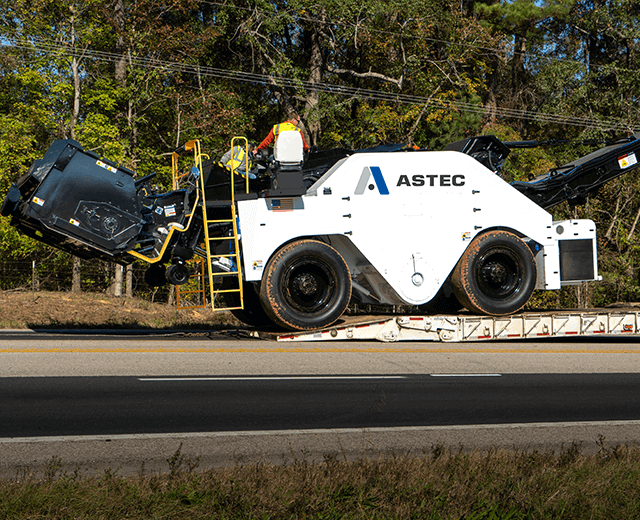The Roadtec SB-3000 Shuttle Buggy MTV being loaded onto a lowboy trailer